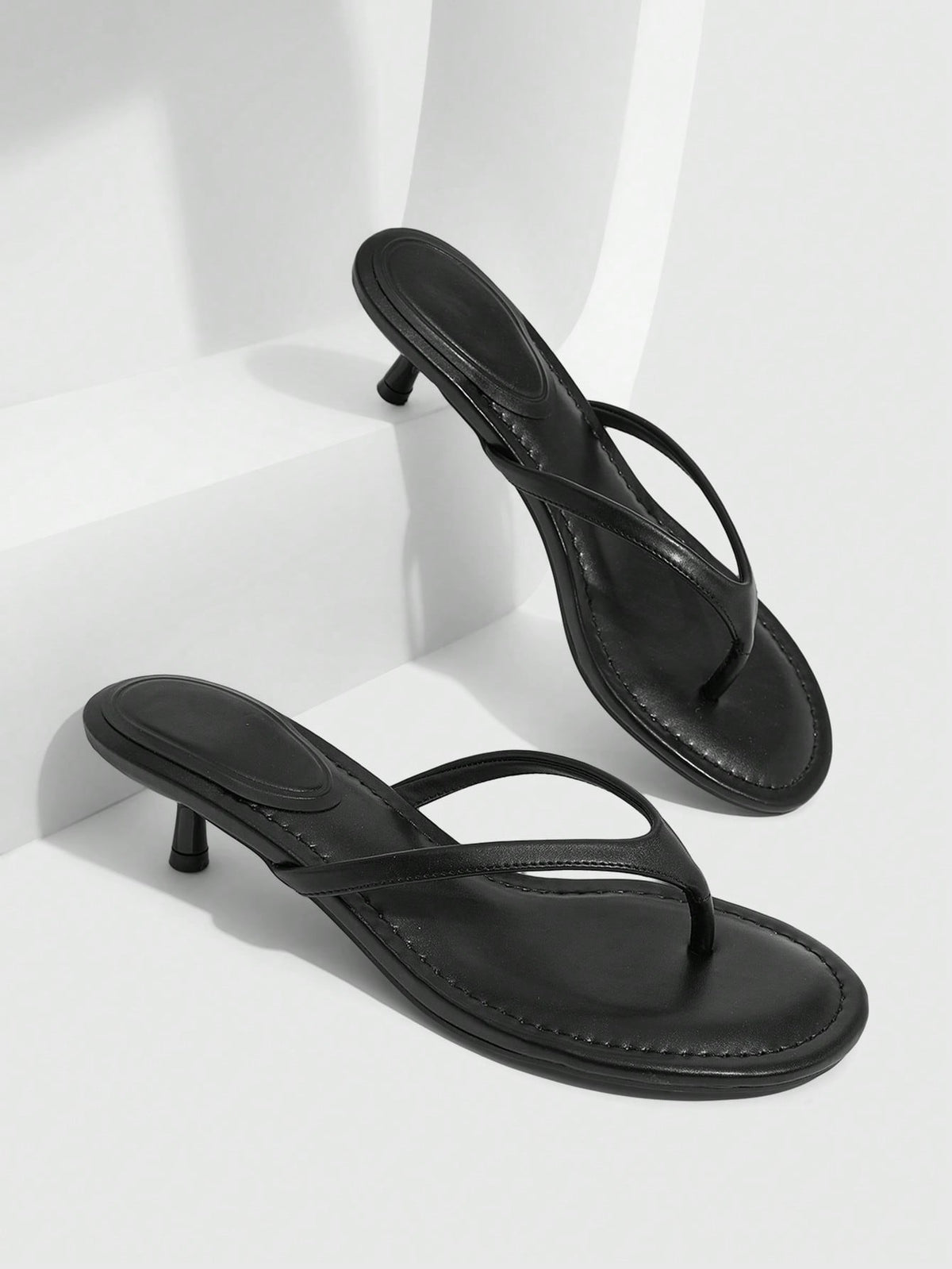 Women's kitten heel flip flop sandals featuring sleek PU leather straps, open toe, and low kitten heel.