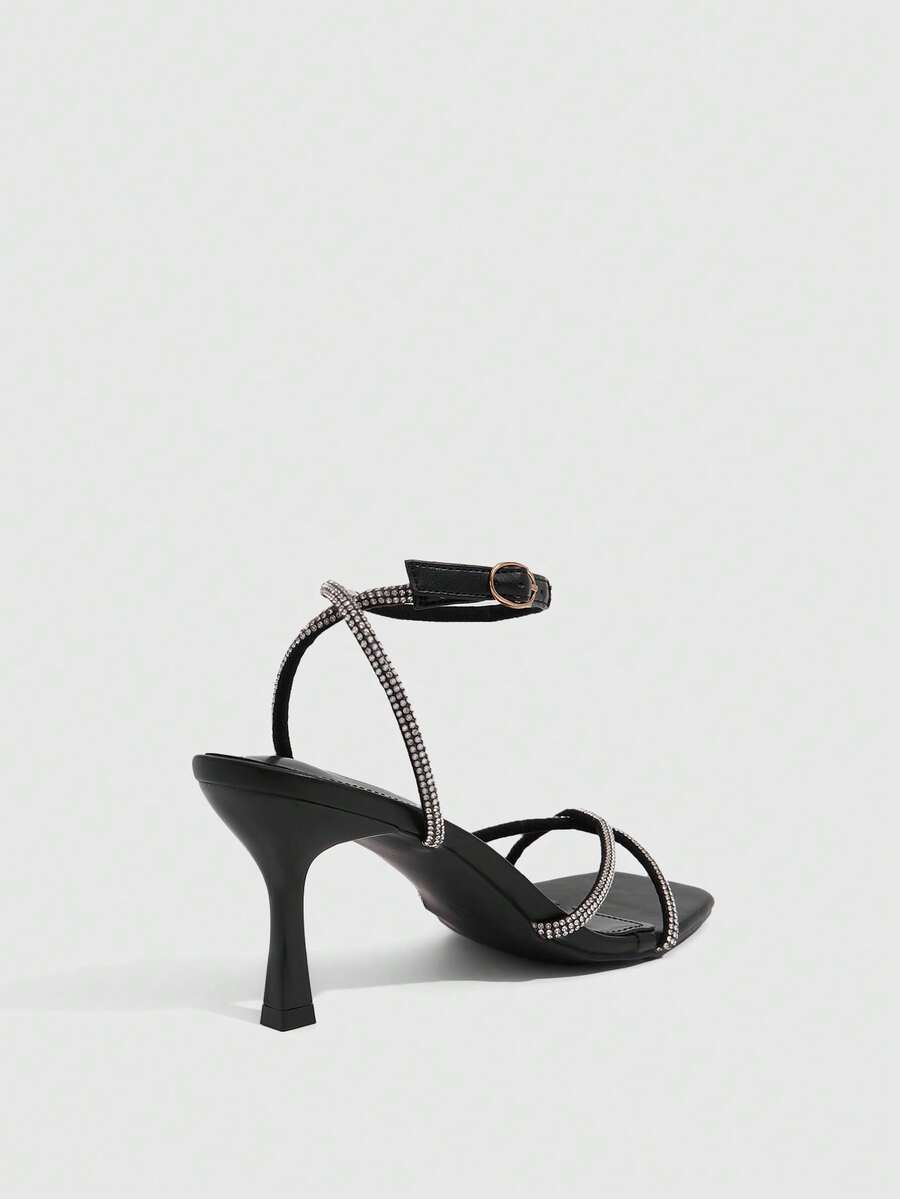 Women's open toe stiletto heel sandals featuring square toe design, criss-cross rhinestone slim straps, and secure ankle strap.