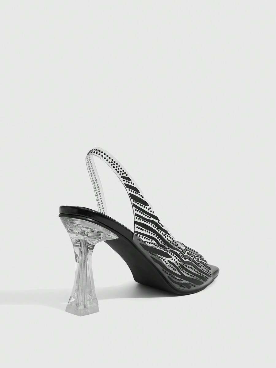 Women's square toe heeled sandals with clear straps, sparkling rhinestone embellishments, and a high pyramid heel.