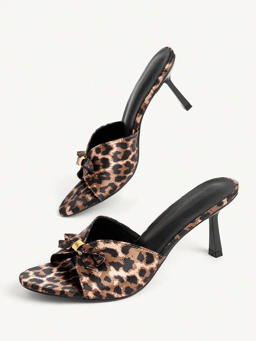 Pair of women's open toe stiletto heeled sandals crafted in satin with a bow accent
