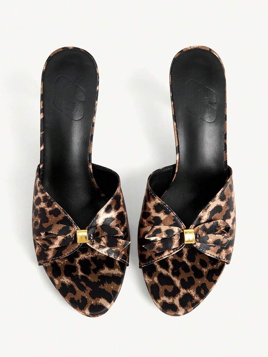 Pair of women's open toe stiletto heeled sandals crafted in satin with a bow accent