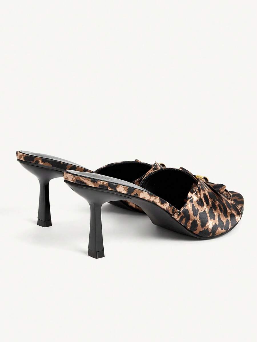 Pair of women's open toe stiletto heeled sandals crafted in satin with a bow accent
