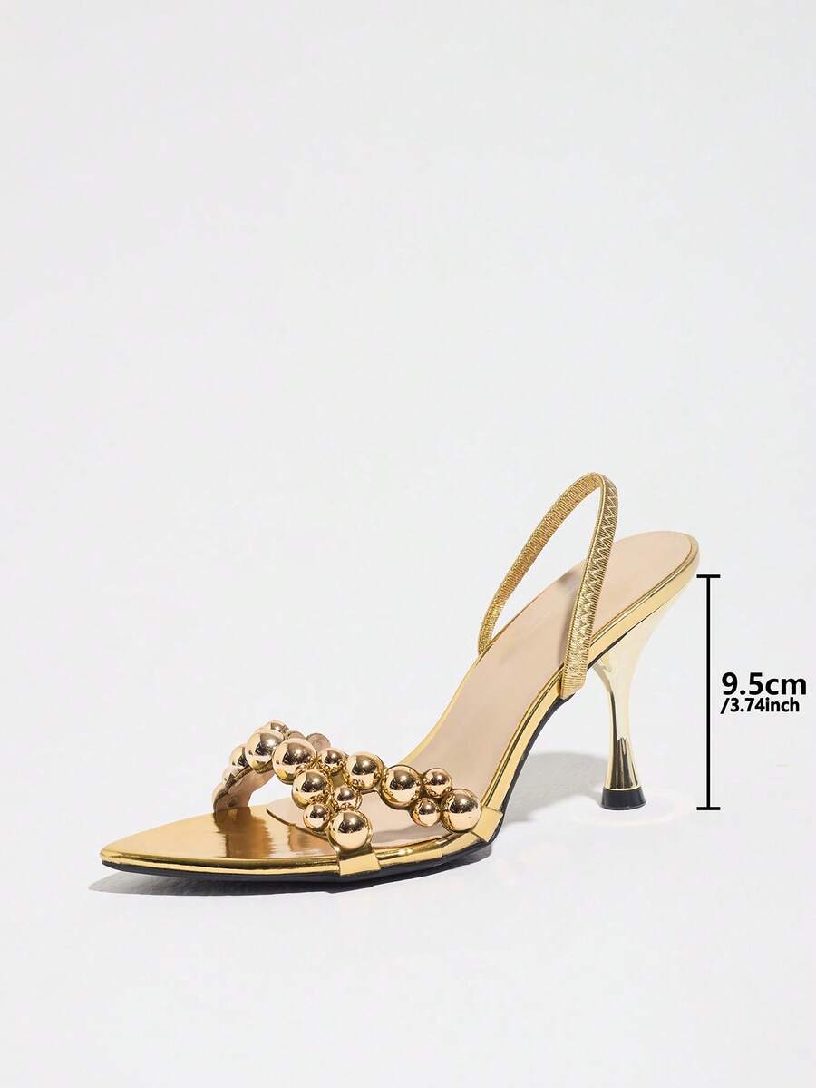 Pointed toe party high heels in gold featuring wavy lace trim, a stiletto heel, and back tie slingback straps.
