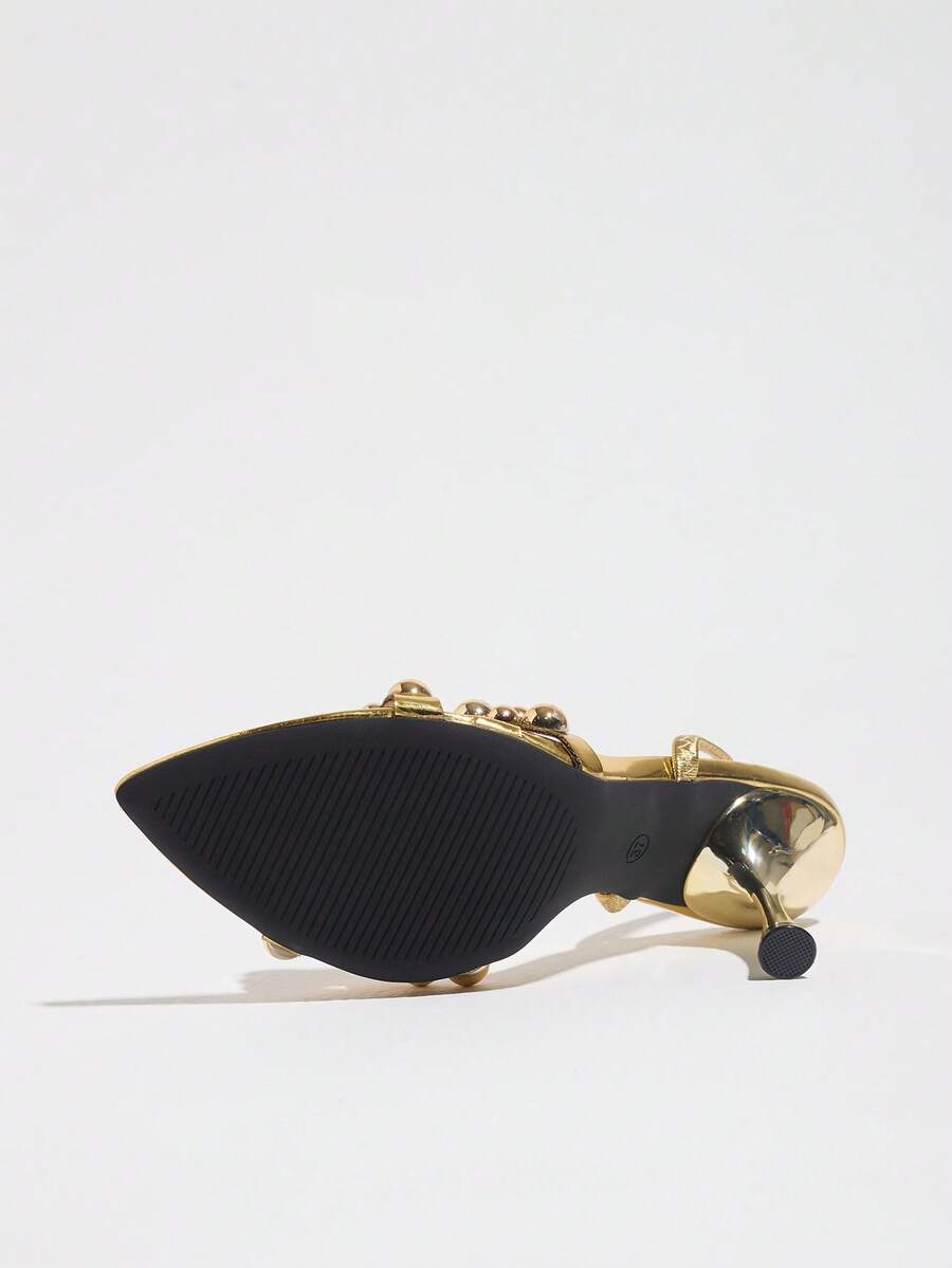 Pointed toe party high heels in gold featuring wavy lace trim, a stiletto heel, and back tie slingback straps.