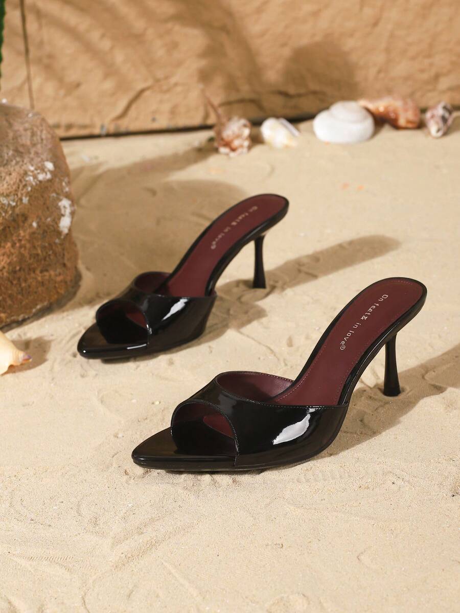 Women's open toe slide sandals featuring sleek patent leather and thin stiletto heels