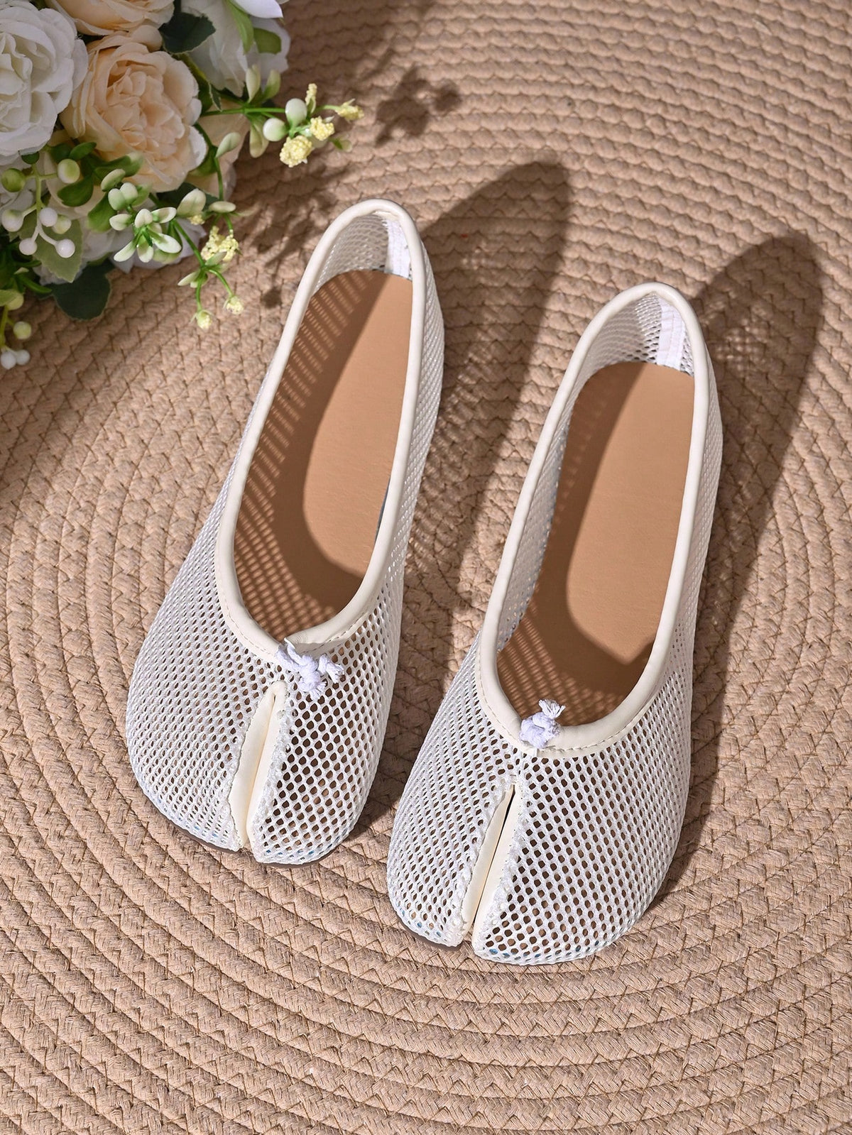 Women's white split-toe slip-on flat shoes with braided accent and rubber sole