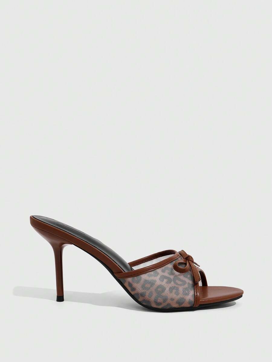 Women's open-toe leopard print mesh stiletto heeled sandals with bow detail.