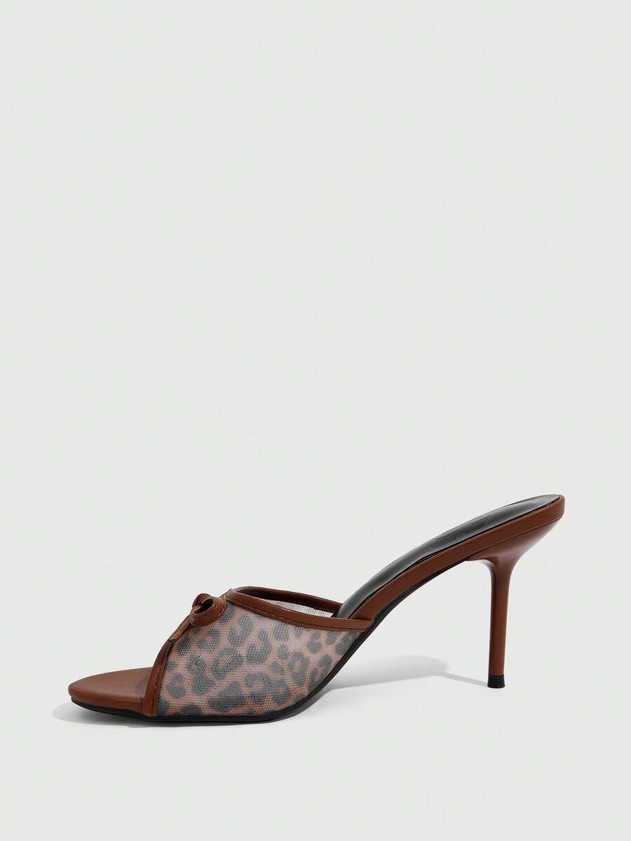 Women's open-toe leopard print mesh stiletto heeled sandals with bow detail.