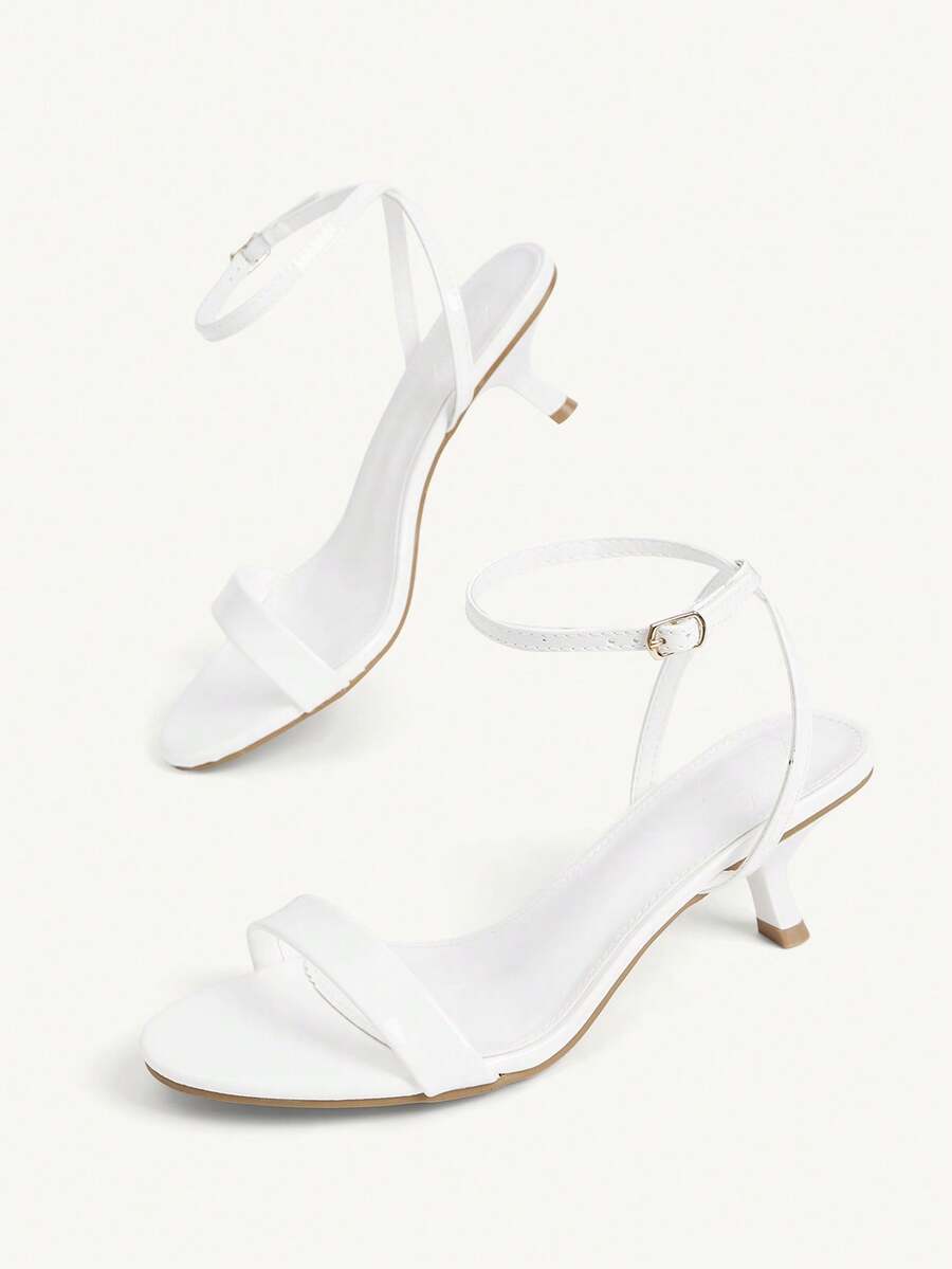 Women's open-toed high-heeled sandals featuring a 5.5cm kitten heel stiletto, sleek ankle strap with buckle closure, and smooth PU leather finish.
