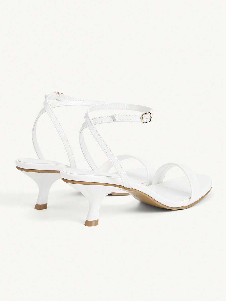 Women's open-toed high-heeled sandals featuring a 5.5cm kitten heel stiletto, sleek ankle strap with buckle closure, and smooth PU leather finish.