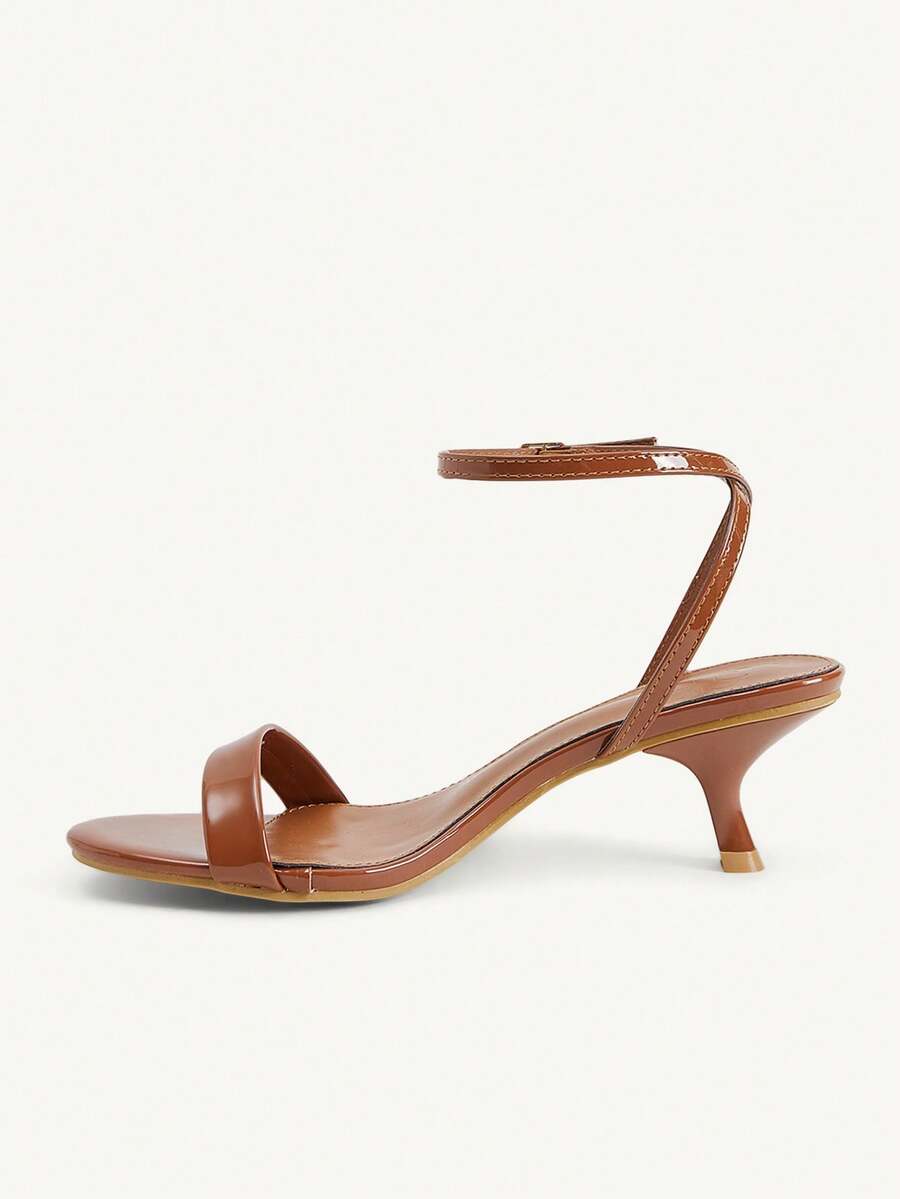 Women's open-toed high-heeled sandals featuring a 5.5cm kitten heel stiletto, sleek ankle strap with buckle closure, and smooth PU leather finish.