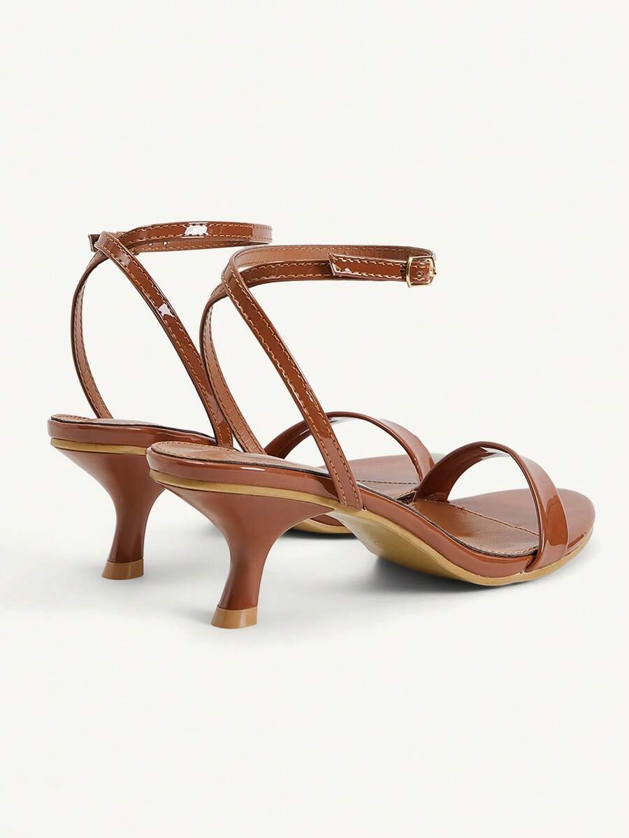 Women's open-toed high-heeled sandals featuring a 5.5cm kitten heel stiletto, sleek ankle strap with buckle closure, and smooth PU leather finish.