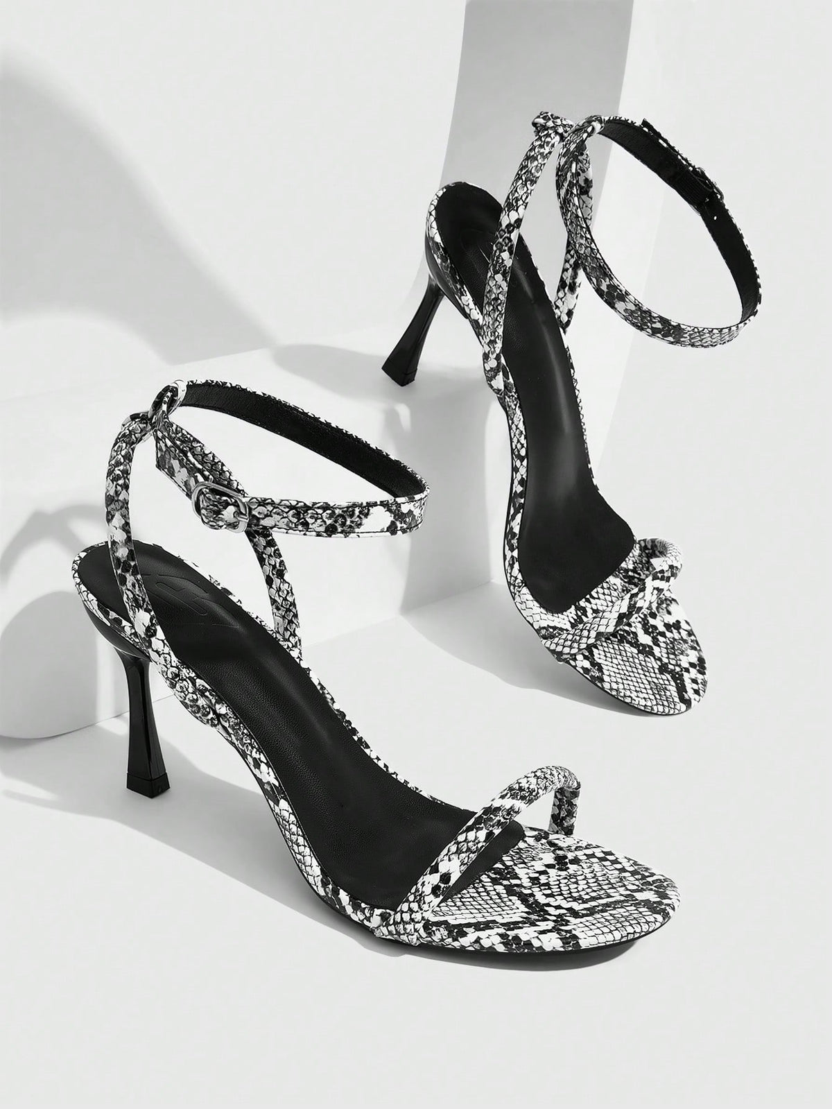 Women's open toe stiletto high heel sandals with an adjustable buckle strap and sleek PU leather finish