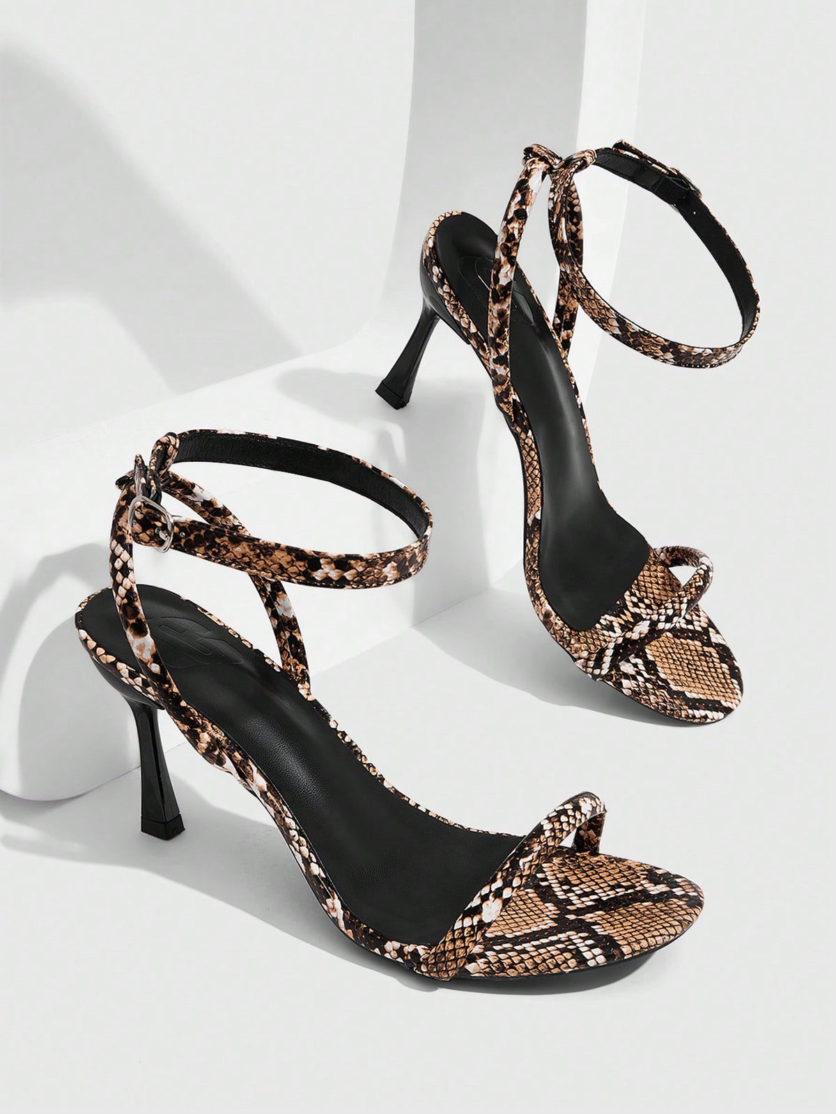 Women's open toe stiletto high heel sandals with an adjustable buckle strap and sleek PU leather finish