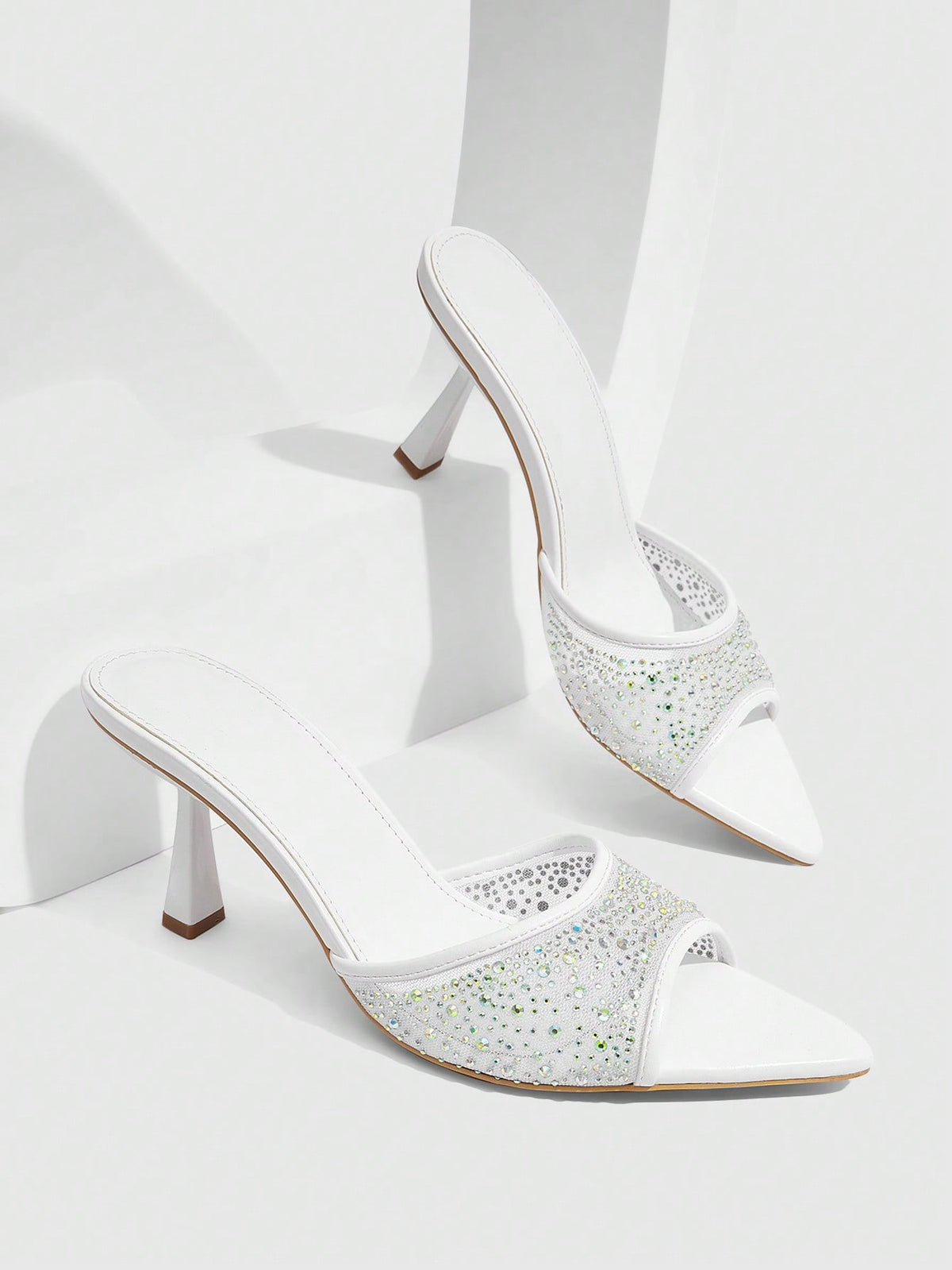 Red mesh pointed open-toe stiletto high-heeled sandals and mules embellished with sparkling rhinestones for wedding and banquet occasions.