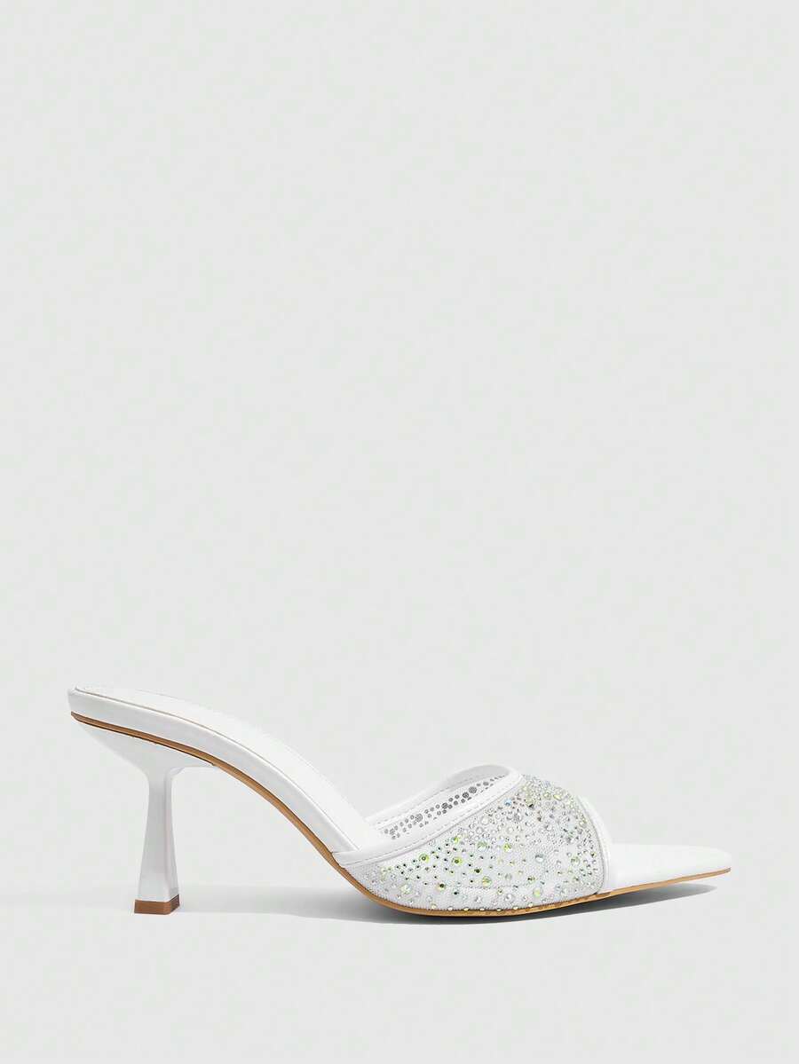 Red mesh pointed open-toe stiletto high-heeled sandals and mules embellished with sparkling rhinestones for wedding and banquet occasions.