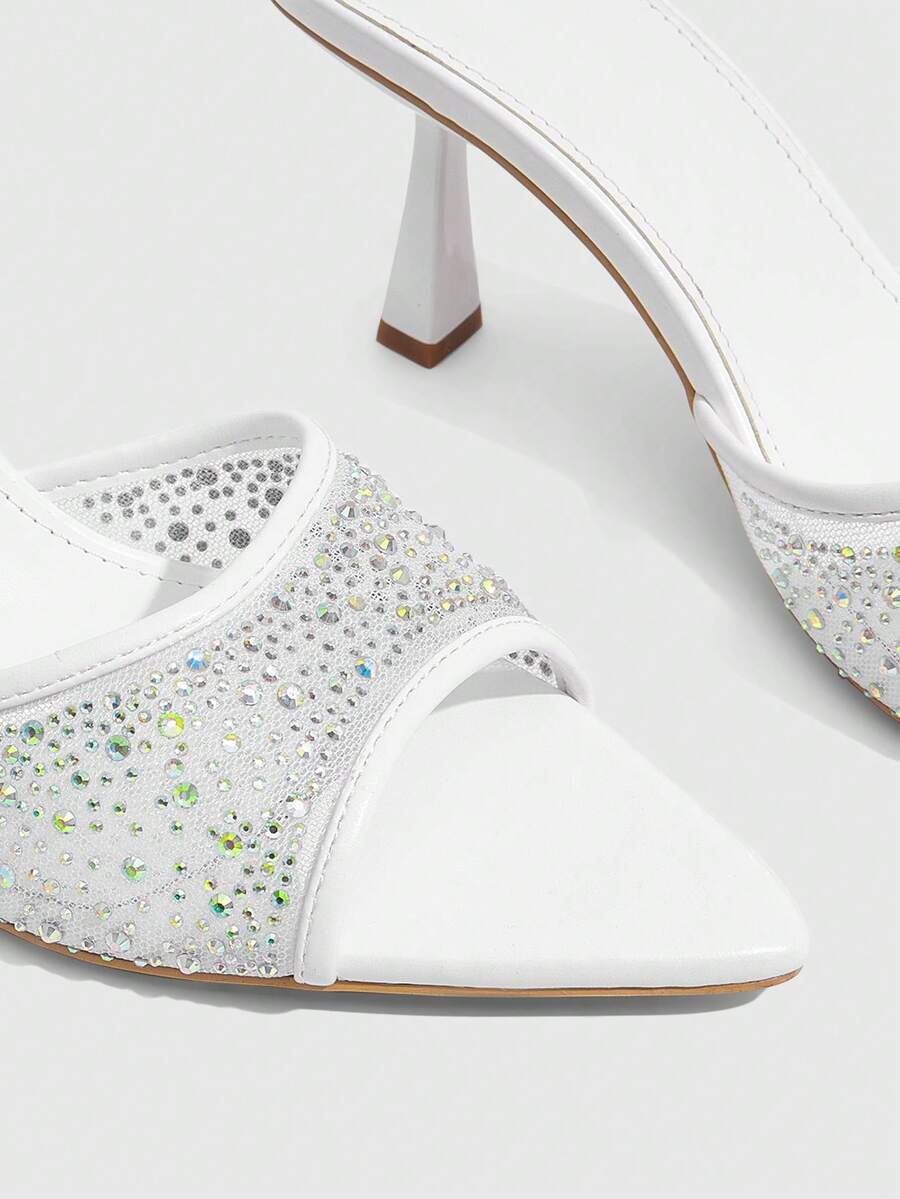 Red mesh pointed open-toe stiletto high-heeled sandals and mules embellished with sparkling rhinestones for wedding and banquet occasions.