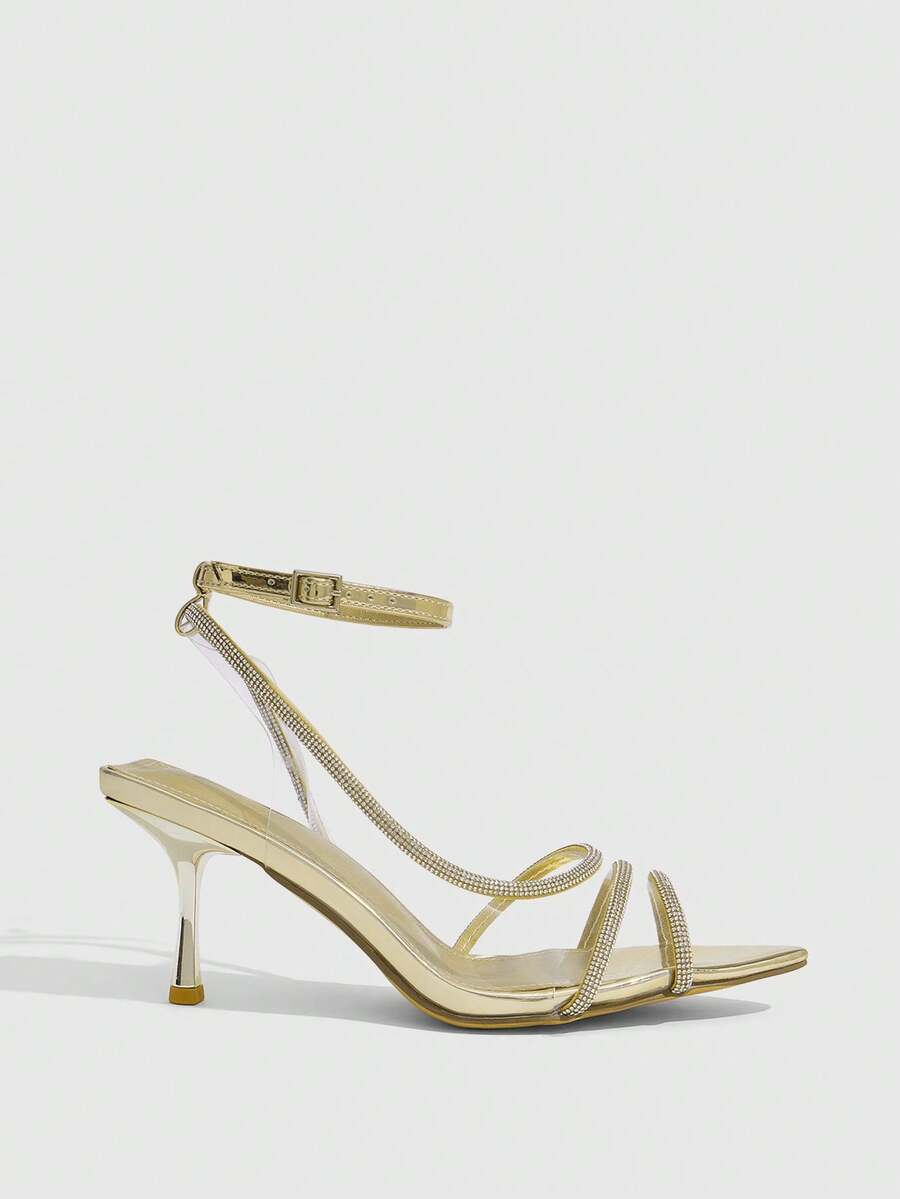 Women's gold open toe high heel sandals featuring sparkling rhinestone ankle strap and transparent upper