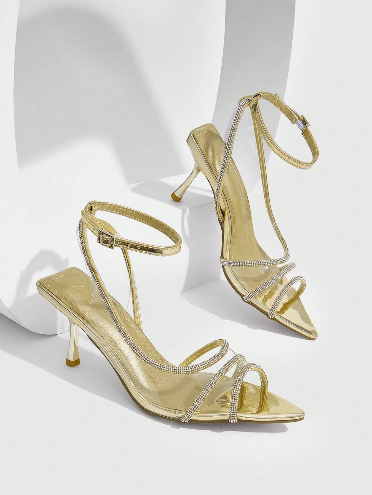 Women's gold open toe high heel sandals featuring sparkling rhinestone ankle strap and transparent upper