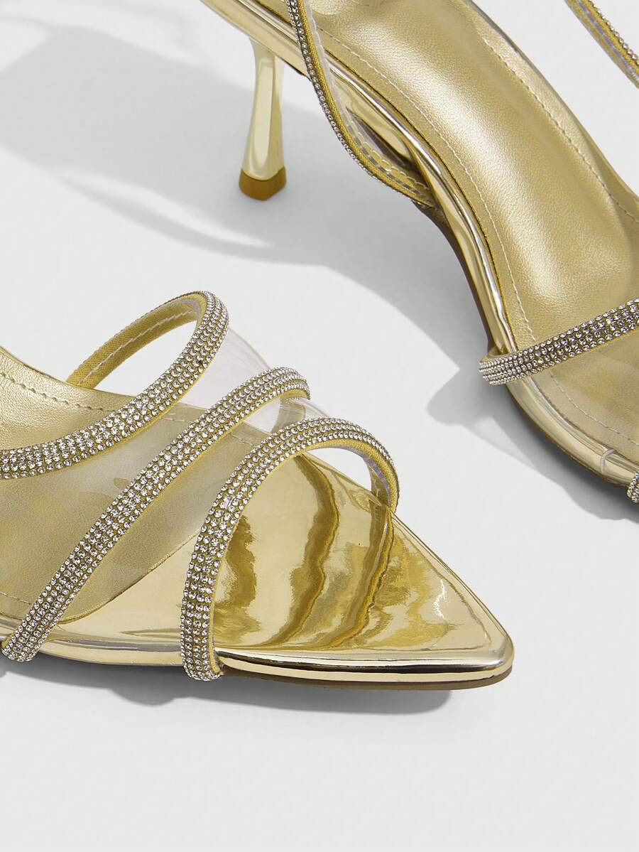 Women's gold open toe high heel sandals featuring sparkling rhinestone ankle strap and transparent upper