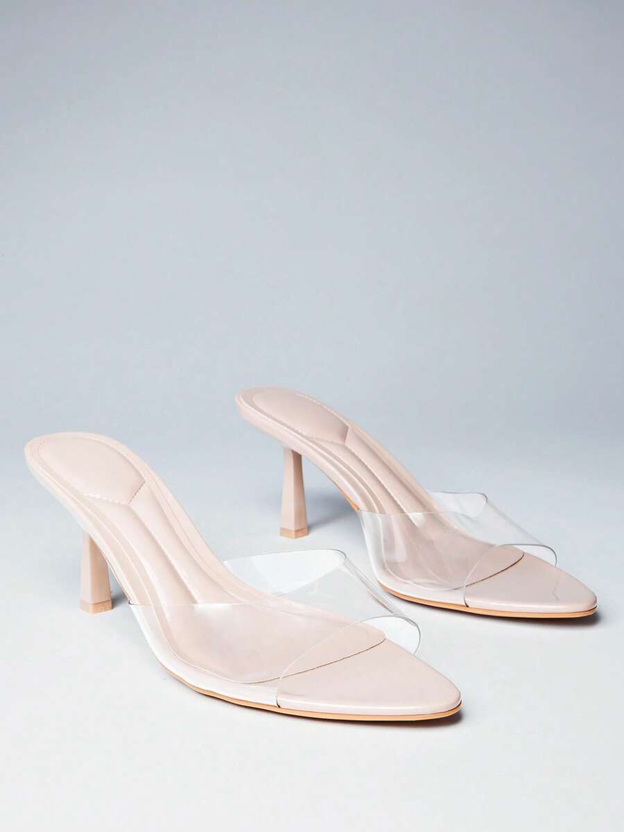 Pair of women's minimalist black pointy toe stiletto heel sandals with slingback straps.