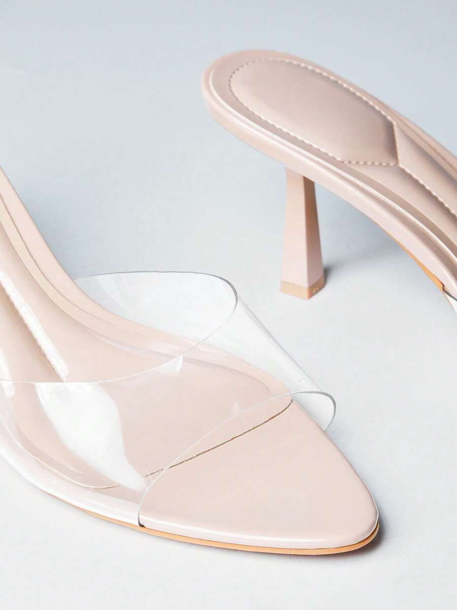 Pair of women's minimalist black pointy toe stiletto heel sandals with slingback straps.
