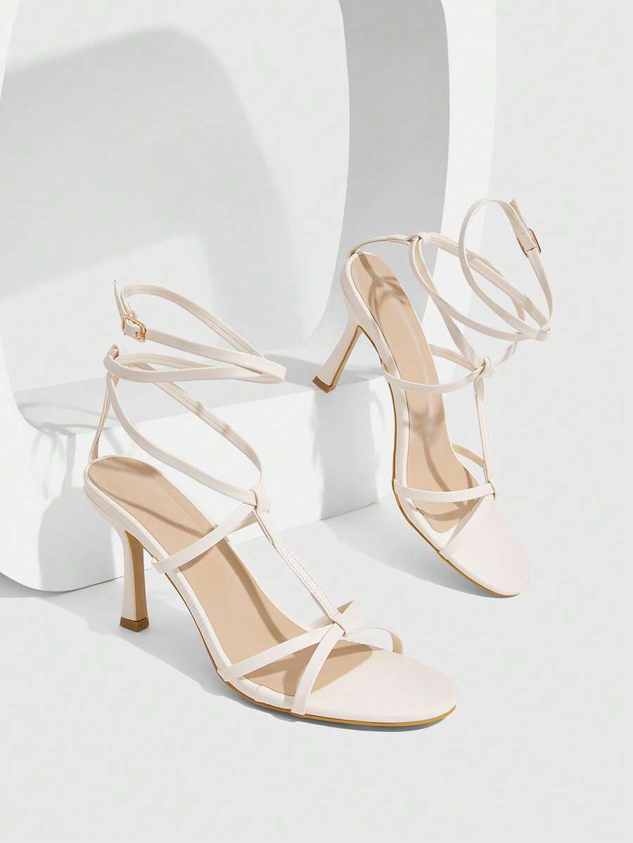 Women's open round toe high heel sandals with thin stiletto heel, hollow strap design, and ankle buckle closure.