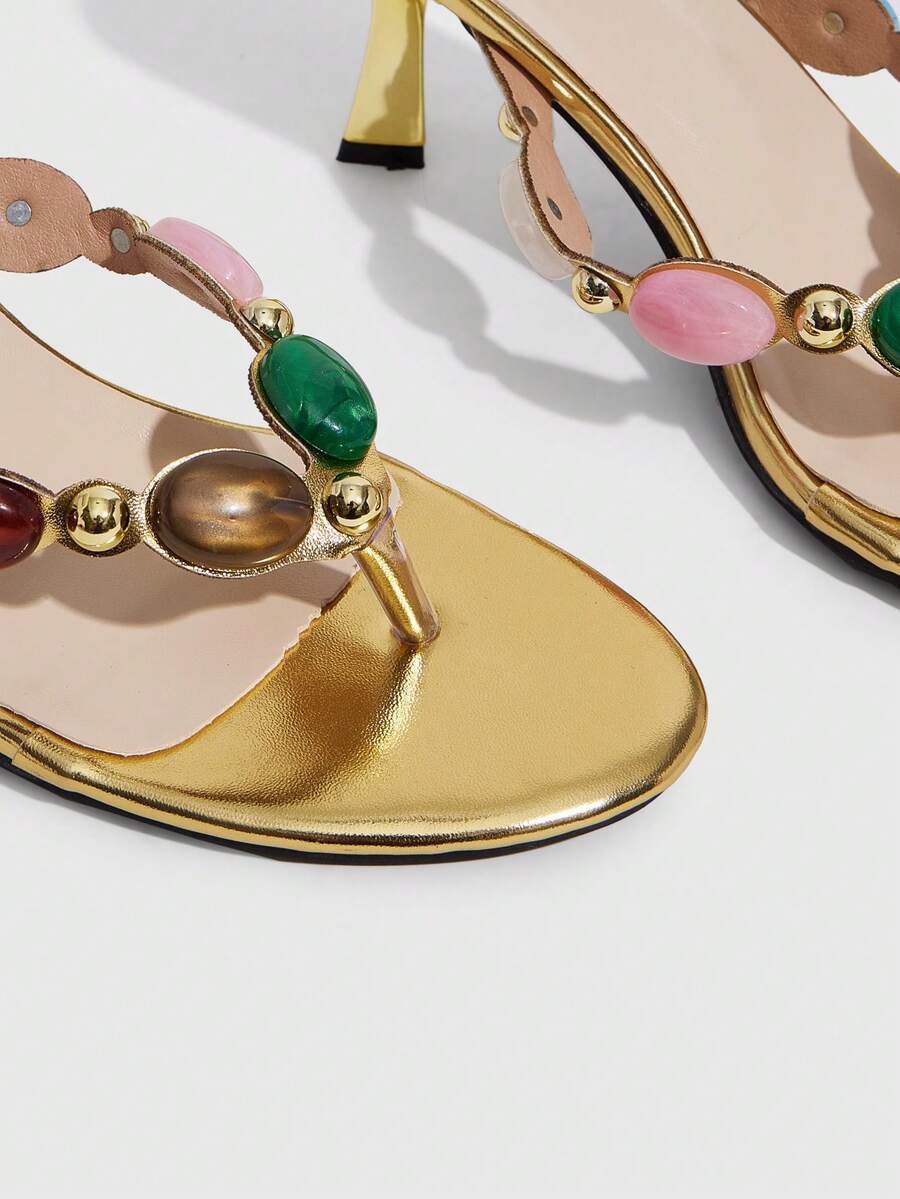 Elegant ladies strappy high-heeled slippers featuring a sleek toe post, buckle accent, and stiletto mid heel in smooth PU leather.