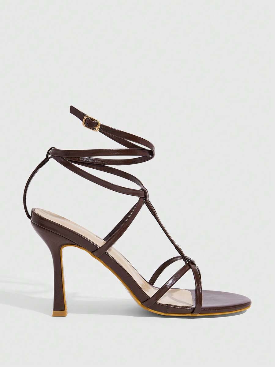 Women's open round toe high heel sandals with thin stiletto heel, hollow strap design, and ankle buckle closure.