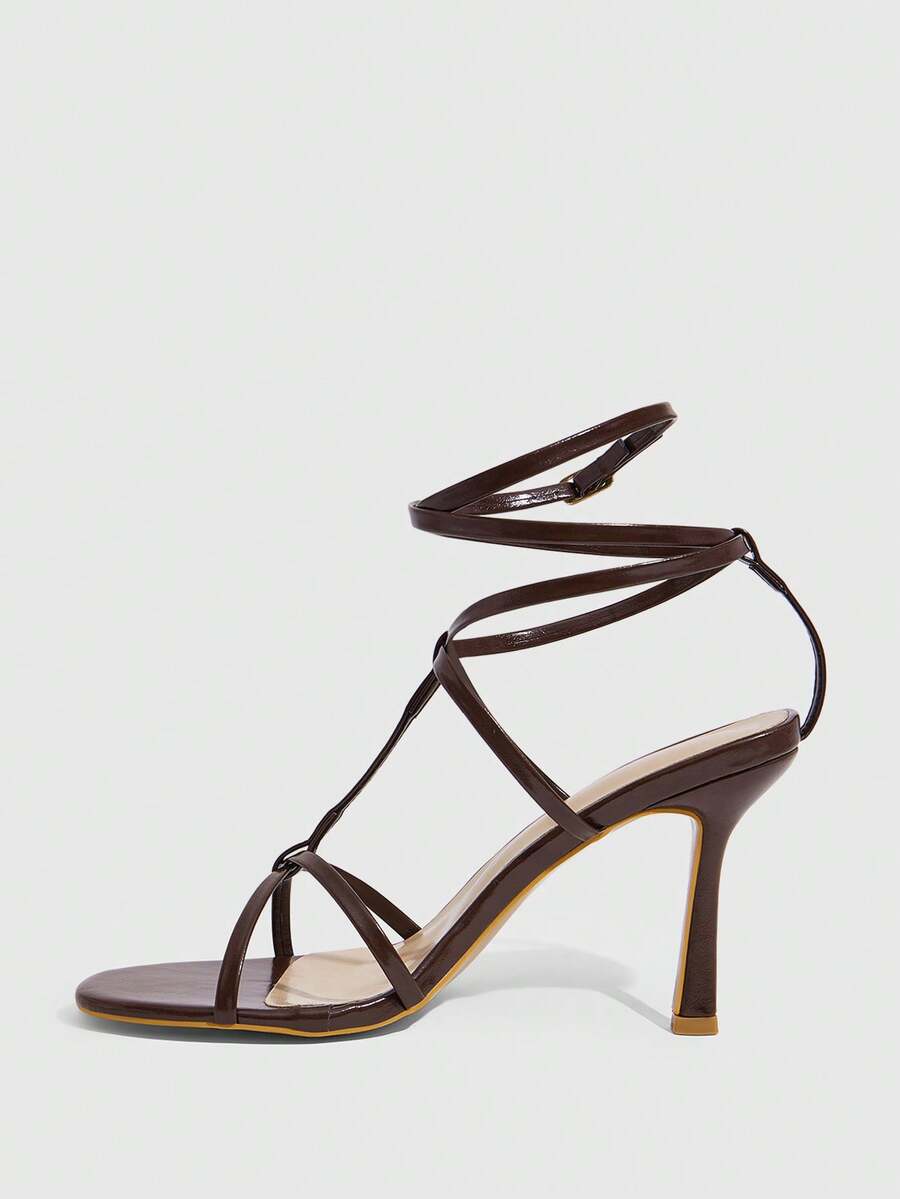 Women's open round toe high heel sandals with thin stiletto heel, hollow strap design, and ankle buckle closure.