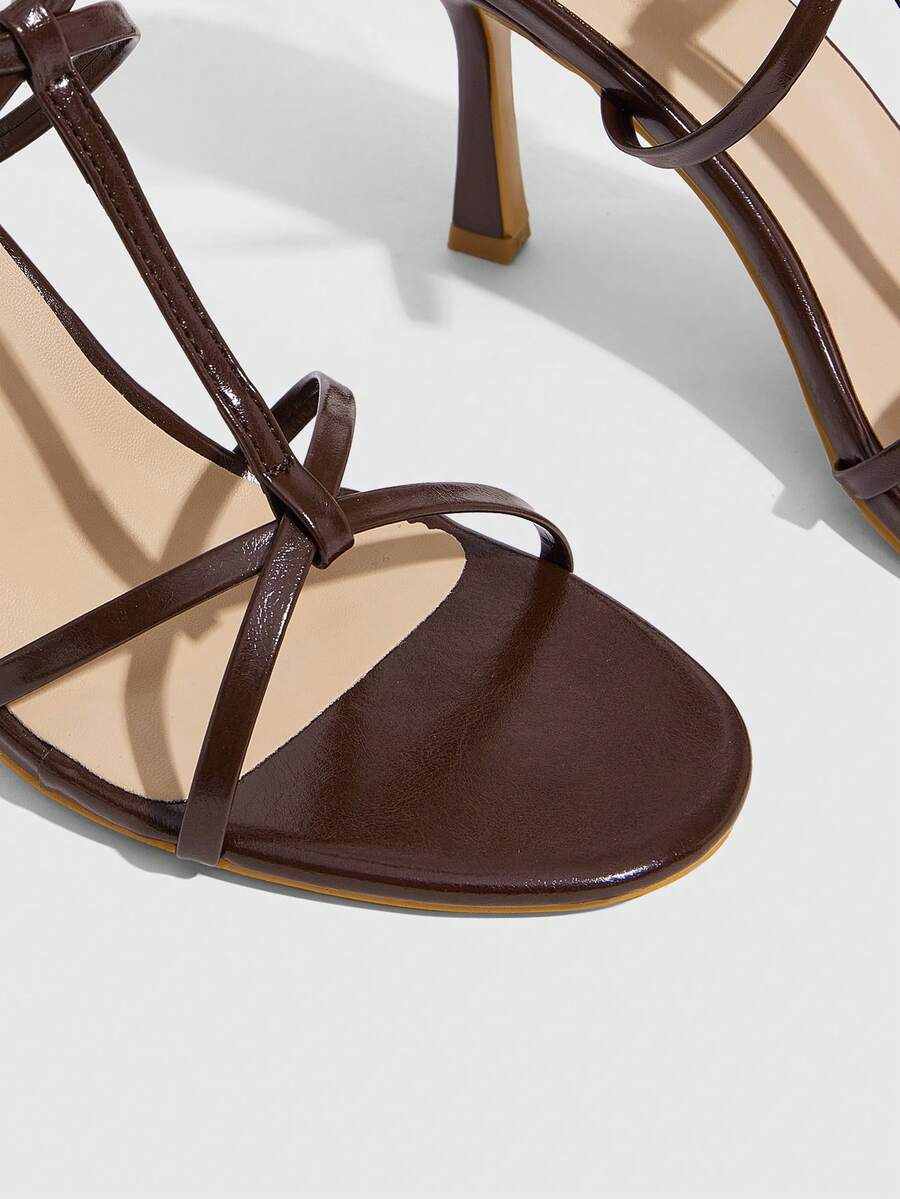 Women's open round toe high heel sandals with thin stiletto heel, hollow strap design, and ankle buckle closure.