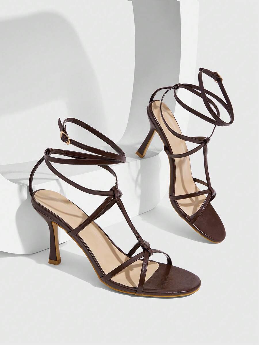 Women's open round toe high heel sandals with thin stiletto heel, hollow strap design, and ankle buckle closure.