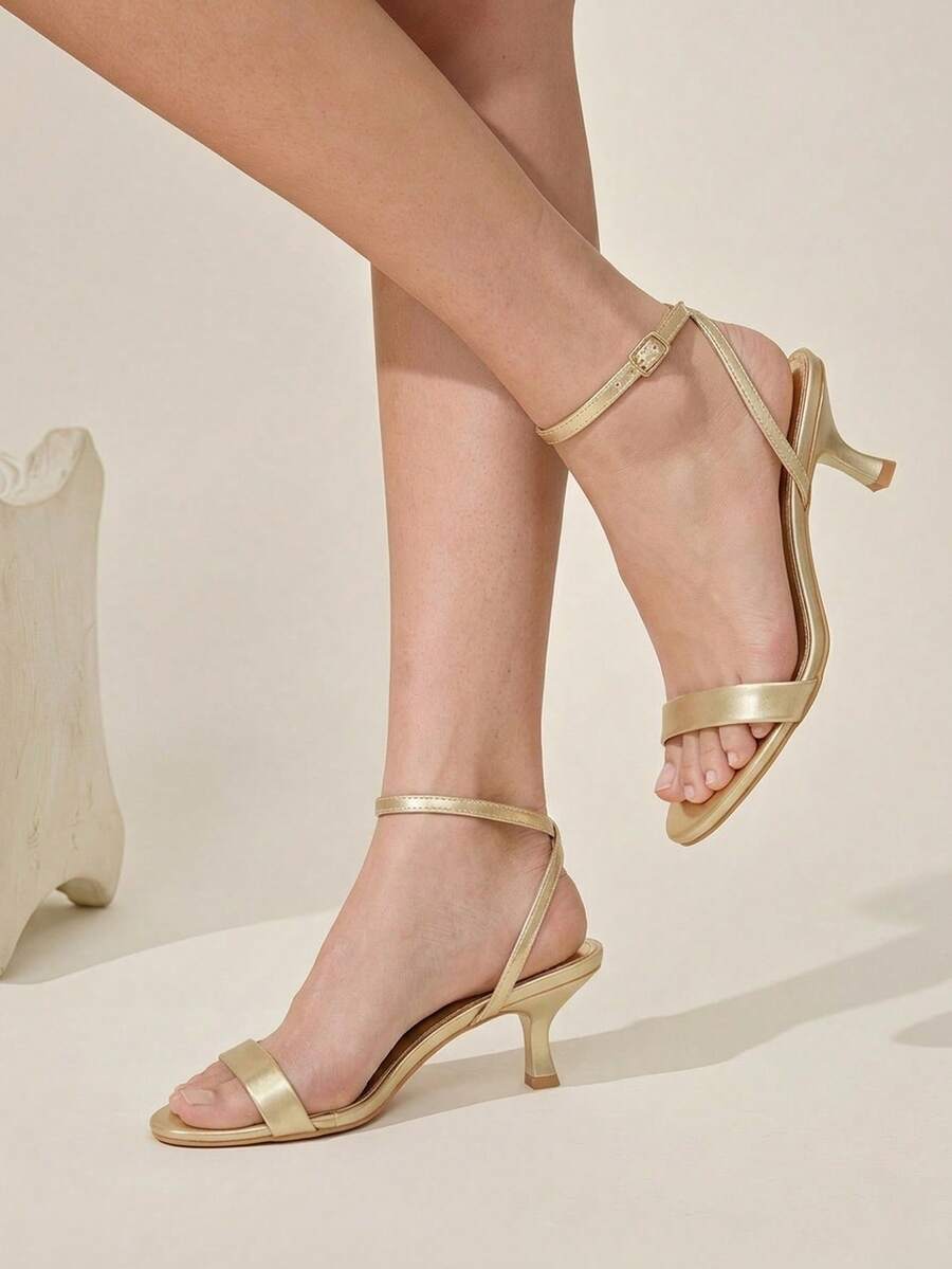 Women's open-toed high-heeled sandals featuring a 5.5cm kitten heel stiletto, sleek ankle strap with buckle closure, and smooth PU leather finish.