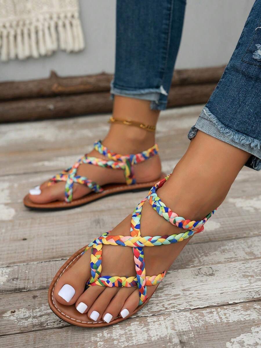 Women's lace-up flat slip-on sandals with round toe and hollow-out PU leather straps for beach and daily wear.