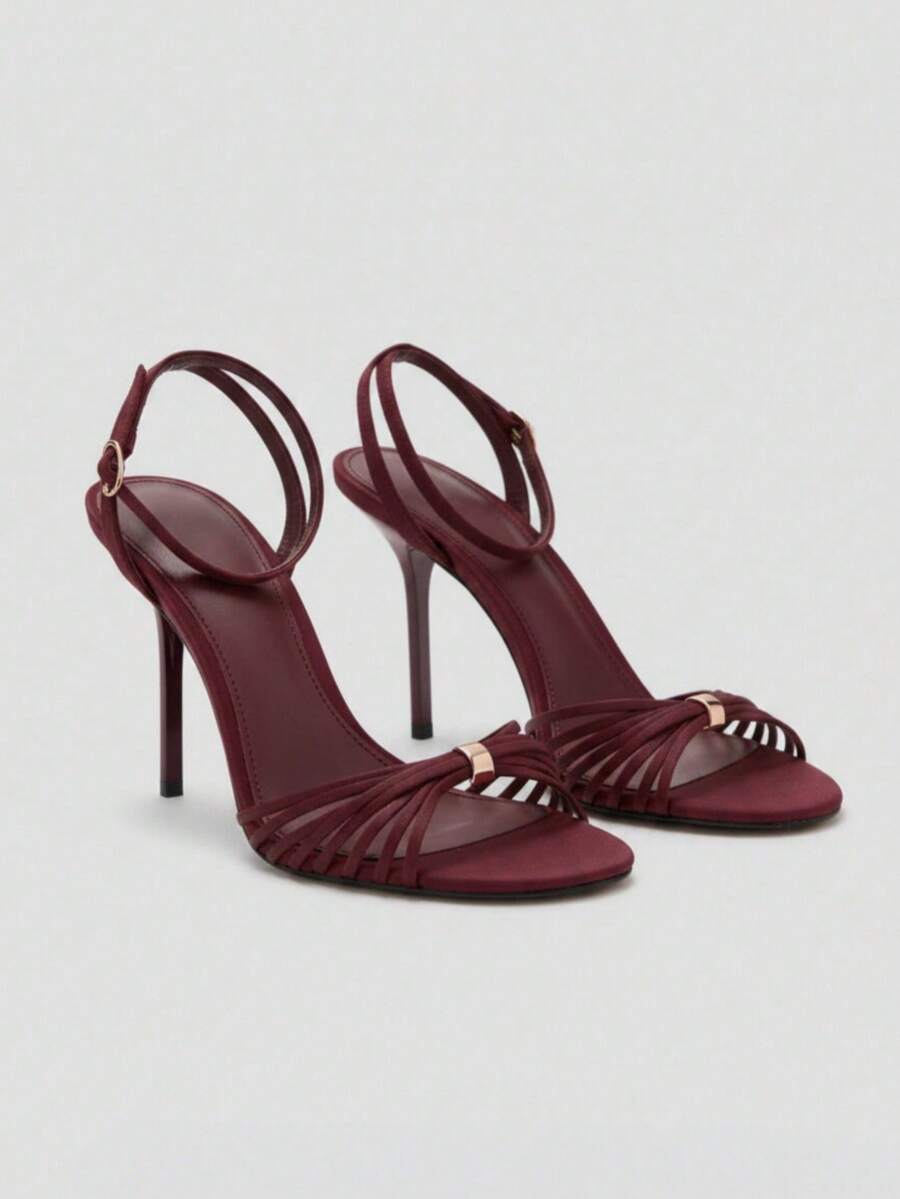 Women's open toe stiletto high heel sandals featuring metallic knot decor and an adjustable ankle buckle strap.