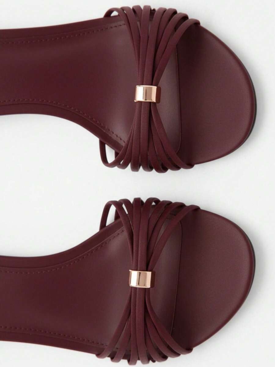 Women's open toe stiletto high heel sandals featuring metallic knot decor and an adjustable ankle buckle strap.