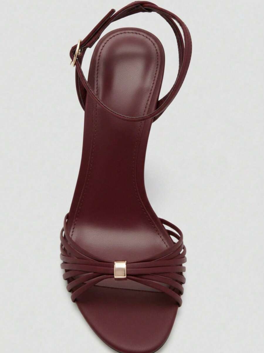 Women's open toe stiletto high heel sandals featuring metallic knot decor and an adjustable ankle buckle strap.