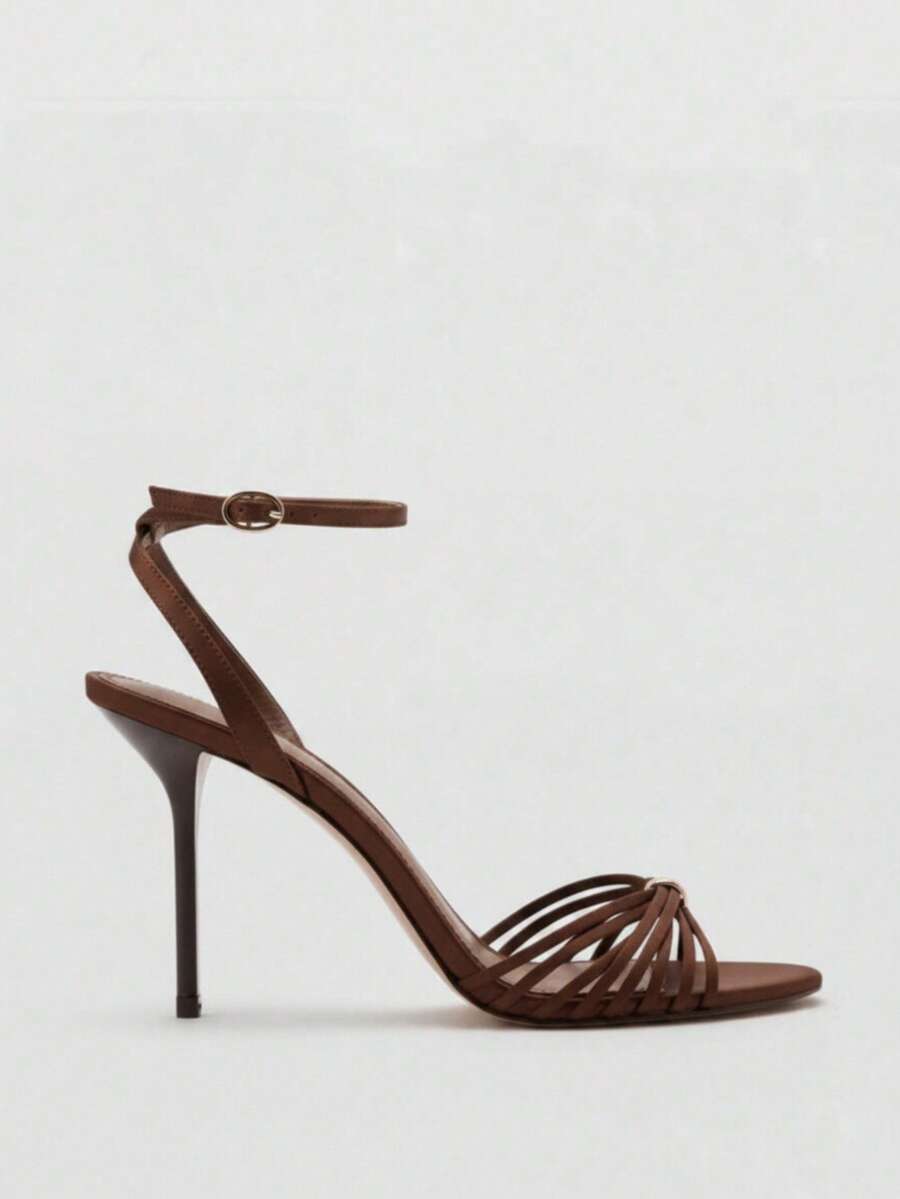 Women's open toe stiletto high heel sandals featuring metallic knot decor and an adjustable ankle buckle strap.