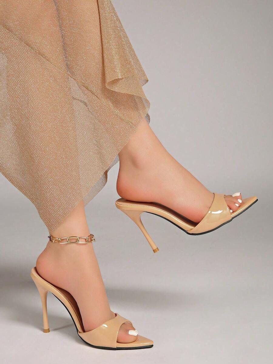 Patent leather open toe slingback slide sandals with stiletto high heels and slip on design.