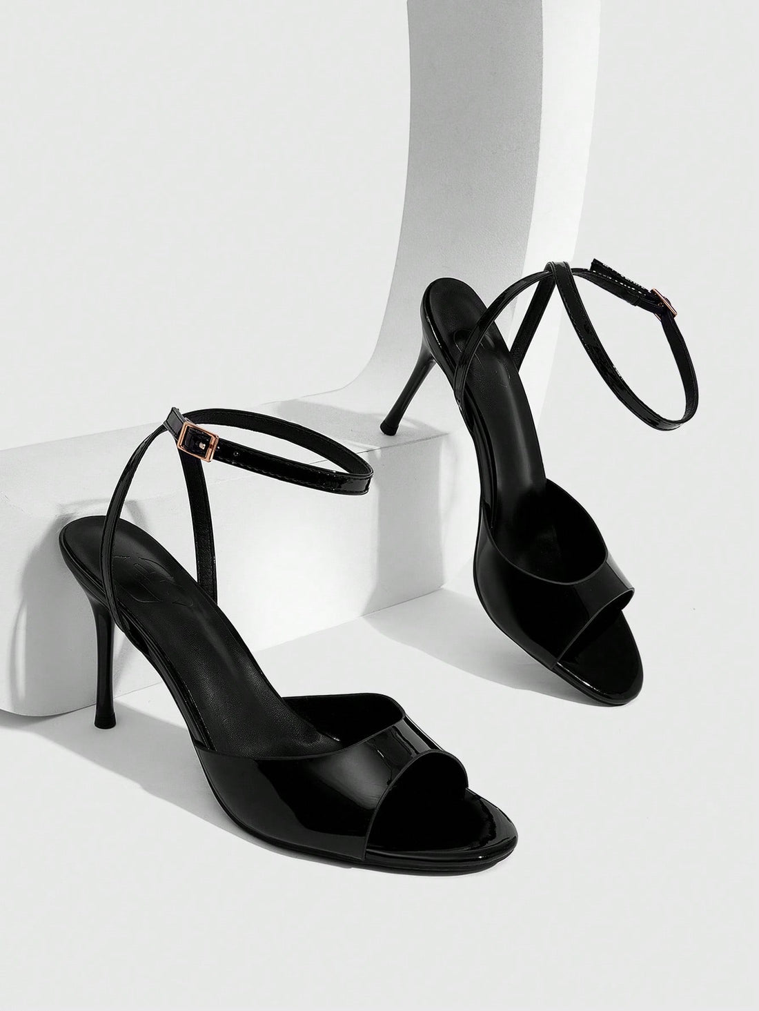 Women's patent leather stiletto sandals with open toe and ankle buckle strap