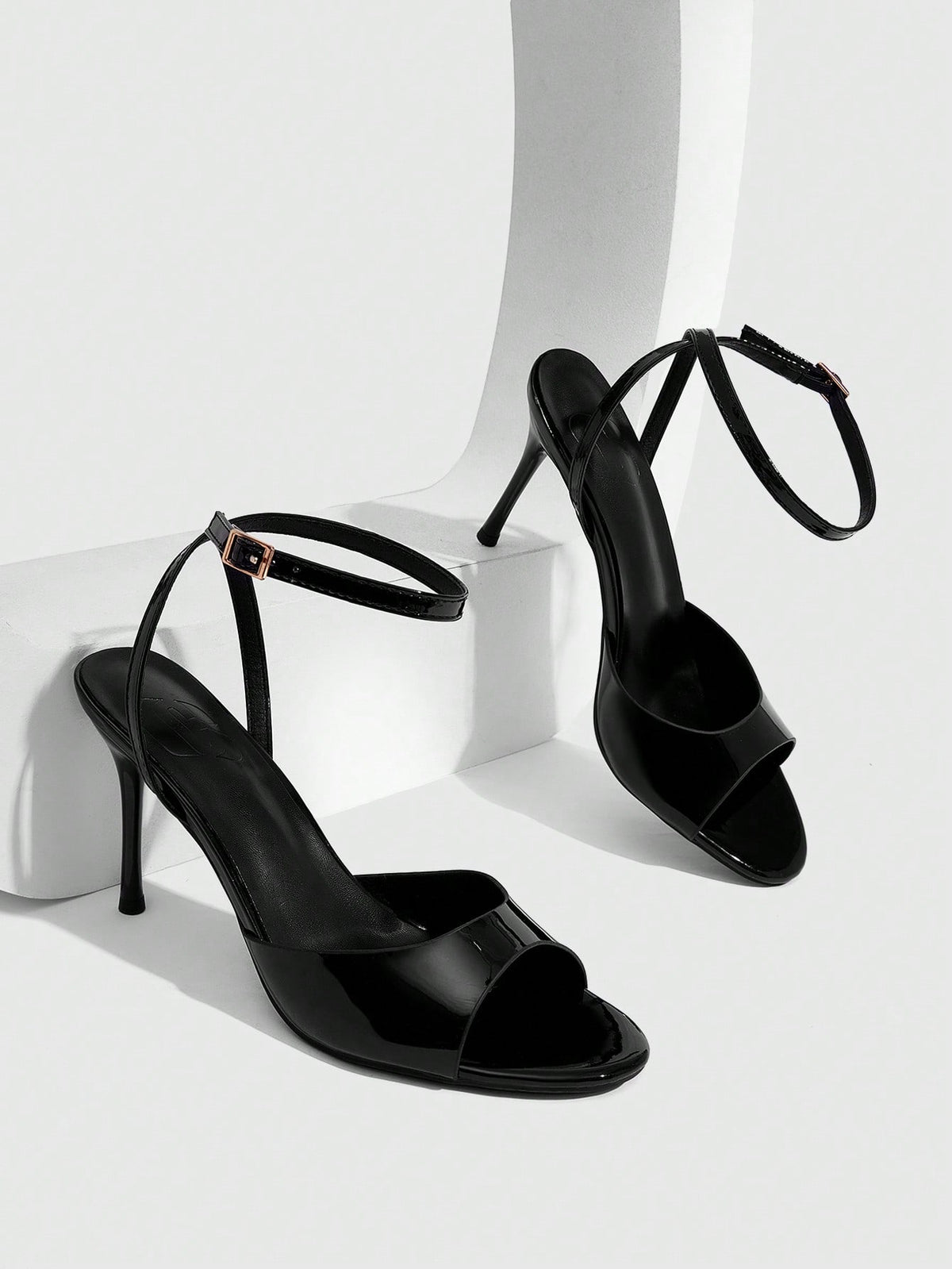Women's patent leather stiletto sandals with open toe and ankle buckle strap