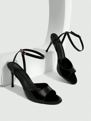 Women's patent leather stiletto sandals with open toe and ankle buckle strap