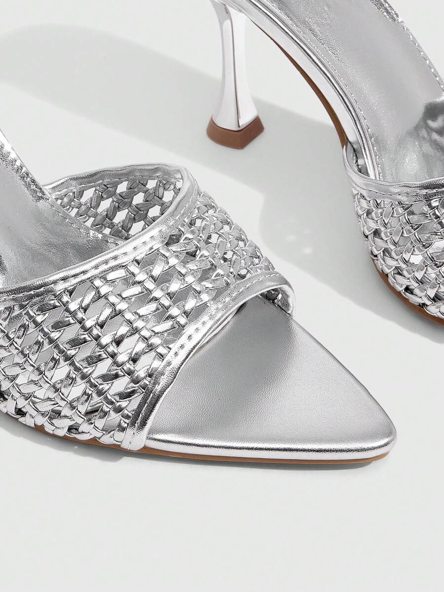 Pair of women's pointed toe stiletto mule sandals with shiny patent upper and slip-on design.