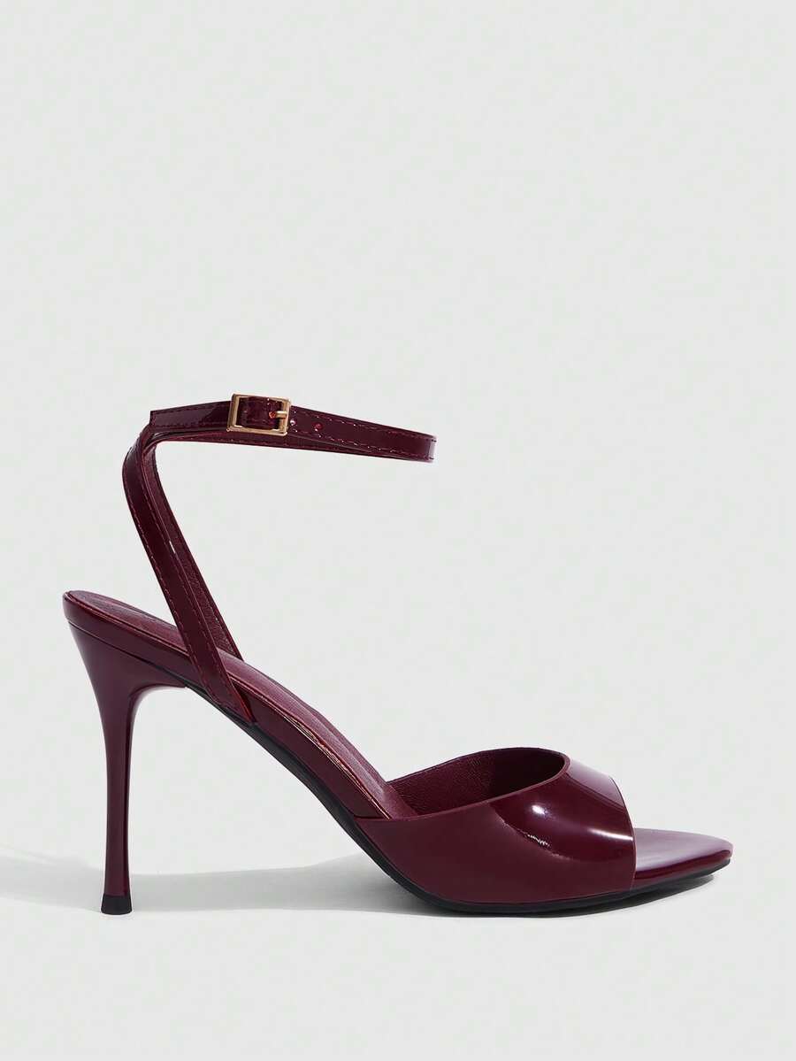 Women's patent leather stiletto sandals with open toe and ankle buckle strap