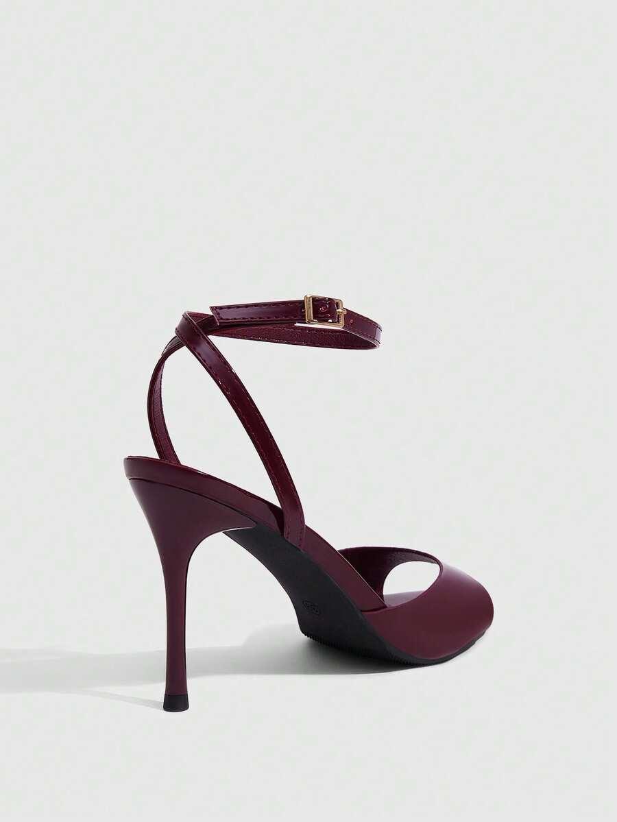 Women's patent leather stiletto sandals with open toe and ankle buckle strap