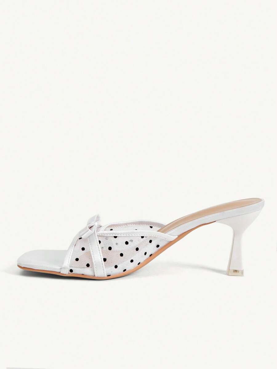 Pair of women's open toe stiletto heeled sandals crafted in satin with a bow accent