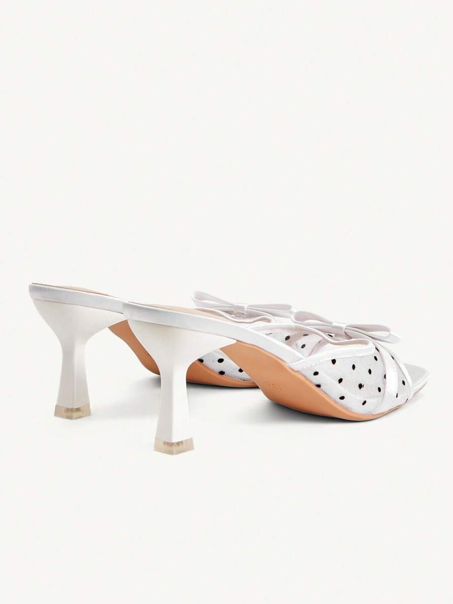 Pair of women's open toe stiletto heeled sandals crafted in satin with a bow accent