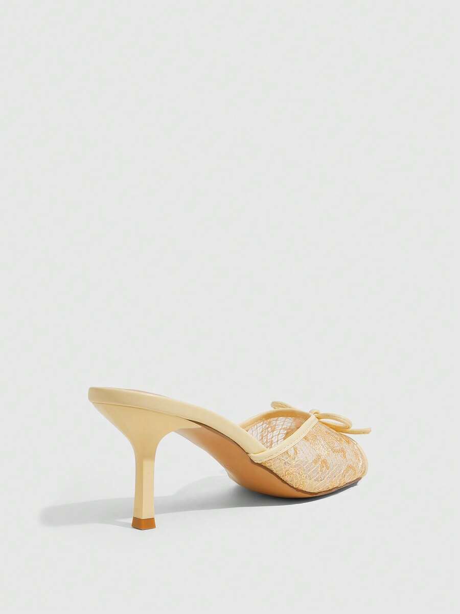 Open toe high heel slide sandals featuring lace details and a bow accent on the upper strap.