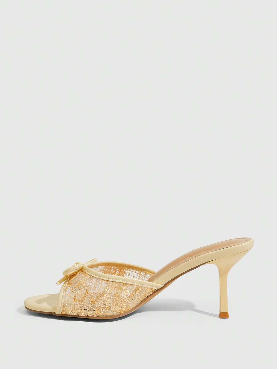 Open toe high heel slide sandals featuring lace details and a bow accent on the upper strap.