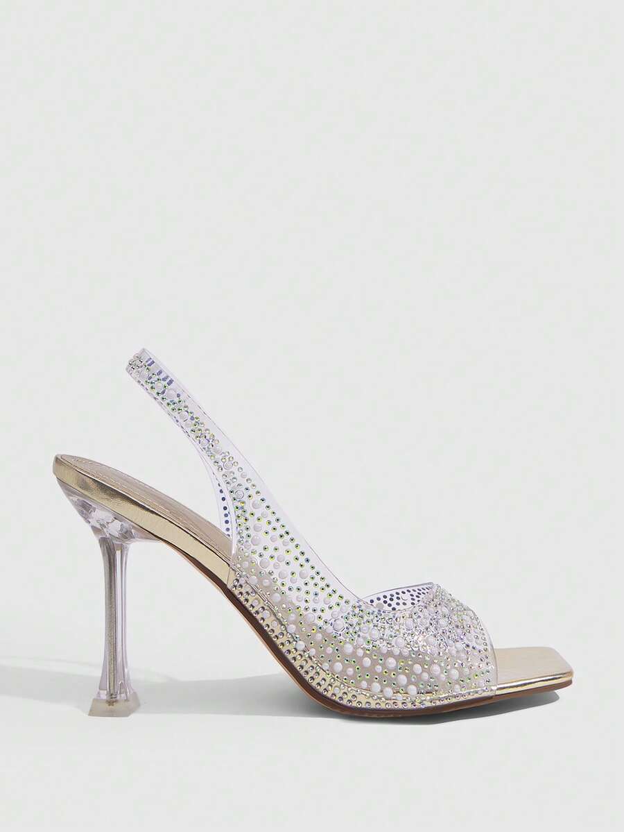 Women's square toe heeled sandals with clear straps, sparkling rhinestone embellishments, and a high pyramid heel.